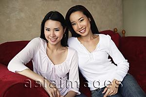 Asia Images Group - two woman smiling on couch