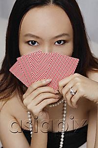 AsiaPix - Young woman holding cards