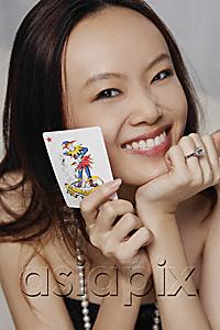 AsiaPix - Young woman holding joker card