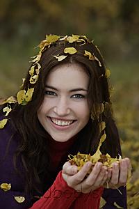 Mind Body Soul - Young woman with fall leaves in hands and hair