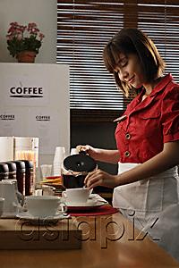 AsiaPix - Waitress in diner pouring coffee