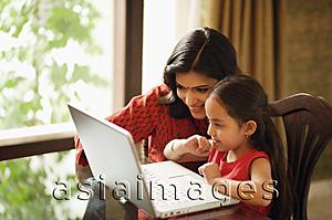 Asia Images Group - mother and daughter working at laptop (horizontal)