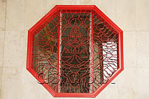 AsiaPix - Octagonal window with lattice work showing Buddha