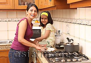 Asia Images Group - Mother and daughter in kitchen