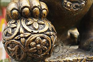 AsiaPix - Close up of statue of lion's paw on orb
