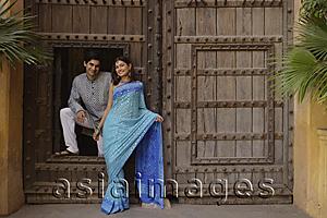 Asia Images Group - young couple posing at wooden doorway