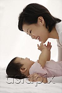 AsiaPix - Woman playing with baby girl
