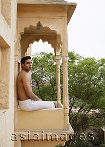 Asia Images Group - young man sitting on terrace balcony