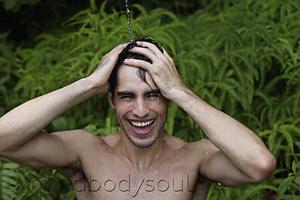 Mind Body Soul - Young man having shower outdoors
