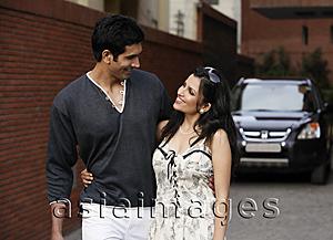 Asia Images Group - couple standing arm in arm