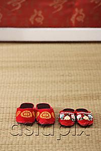 AsiaPix - Still life of 2 pairs of red shoes on weaved mat