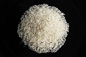 AsiaPix - a pile of uncooked rice against a black plate