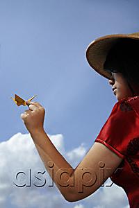 AsiaPix - Chinese woman with conical hat holding a paper crane
