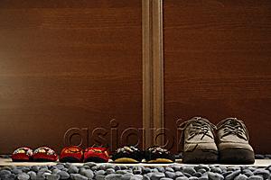 AsiaPix - slippers and shoes placed in a row at door front