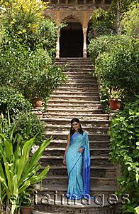 Asia Images Group - young woman in sari, on steps