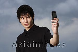 Asia Images Group - young man taking own picture