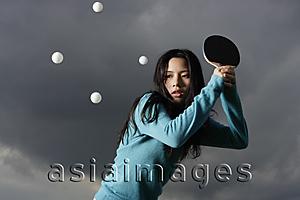Asia Images Group - young lady hitting ping pong balls