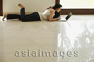 Asia Images Group - young woman on floor using computer
