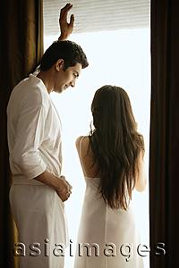 Asia Images Group - couple in front of bedroom window