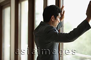 Asia Images Group - businessman with hands on window