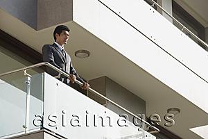 Asia Images Group - businessman standing at balcony
