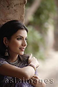 Asia Images Group - young woman in sari, sitting peacefully