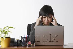 AsiaPix - business woman looking stressed at computer