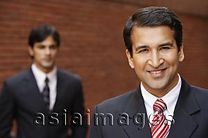 Asia Images Group - two businessmen, one smiling