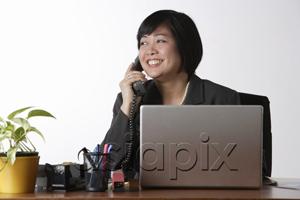 AsiaPix - woman sitting at desk talking on phone