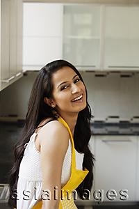 Asia Images Group - young woman smiling in kitchen