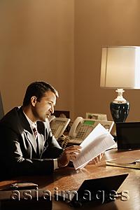 Asia Images Group - businessman reading documents in office