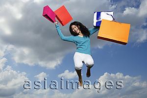 Asia Images Group - young lady jumping with shopping bags