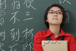 AsiaPix - woman looking up in front of chinese characters written in chalk