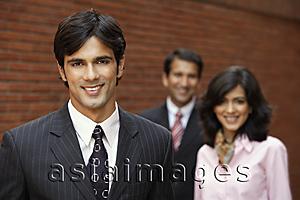 Asia Images Group - two businessmen and one businesswoman, smiling