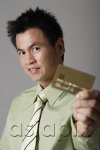 AsiaPix - man smiling behind gold credit card