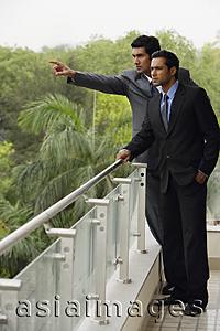 Asia Images Group - businessmen standing at balcony