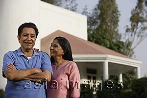 Asia Images Group - smiling couple standing in front of house