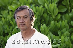 Asia Images Group - Portrait of mature man, greenery background