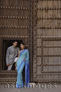Asia Images Group - young couple posing at wooden doorway