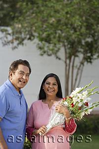 Asia Images Group - couple smiling, woman with bouquet