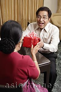 Asia Images Group - man giving woman a gift