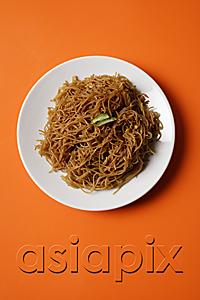AsiaPix - Noodles on plate on orange place mat.