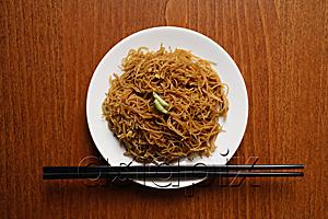 AsiaPix - Chinese noodles on plate with chopsticks.