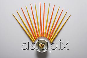AsiaPix - Orange and yellow chopsticks lined up over dim sum.