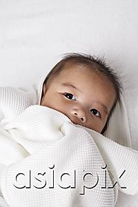 AsiaPix - Head shot of Chinese baby wrapped up in a white blanket.
