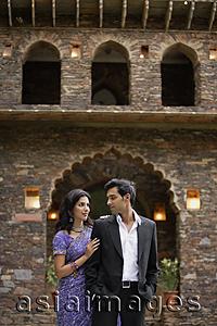 Asia Images Group - young couple standing in front of brick house