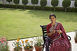 Asia Images Group - woman wearing a sari, knitting