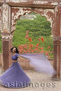 Asia Images Group - young woman in sari, dancing on terrace