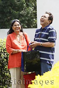 Asia Images Group - couple laughing with shopping bags
