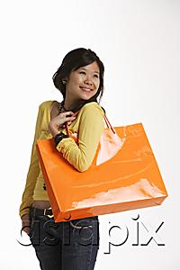 AsiaPix - Young woman holding large shopping bag.